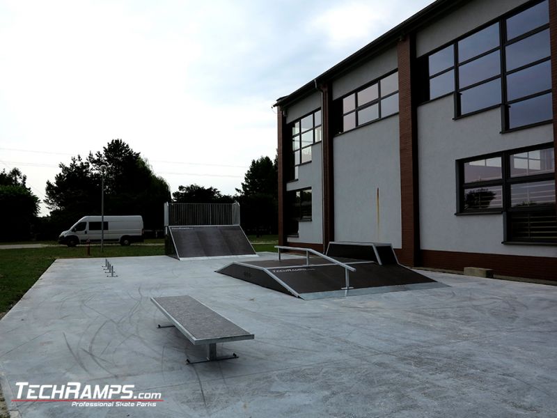 Wooden skatepark and a building in the background